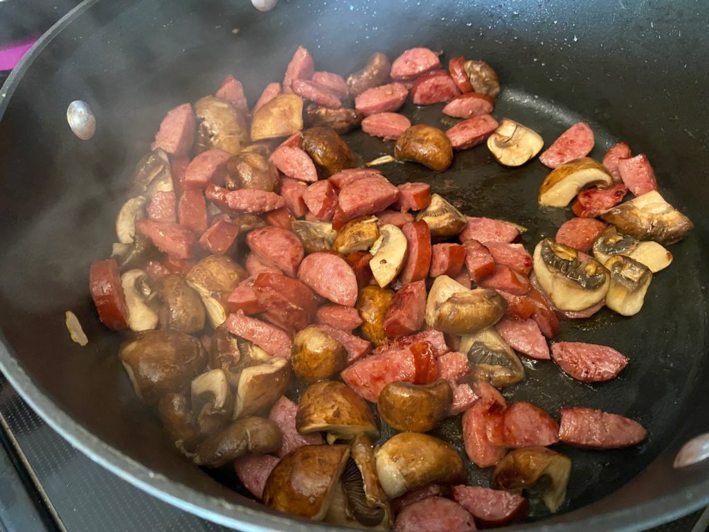 cooking sausage and mushrooms